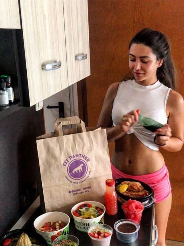 girl in the kitchen with food boxes from Fit Panther